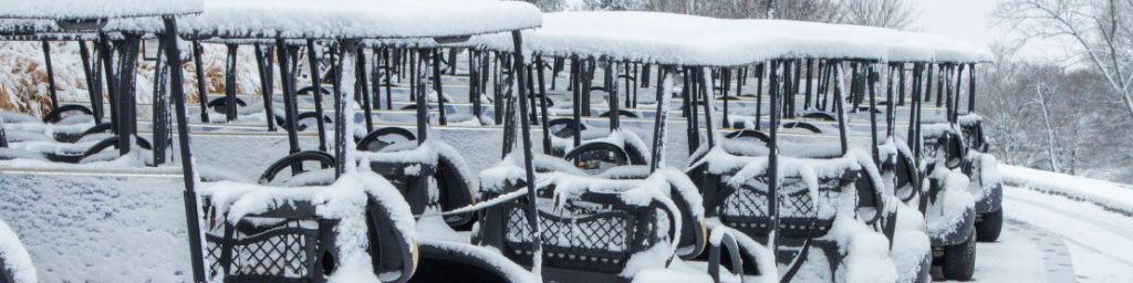 Golf carts covered in snow during winter