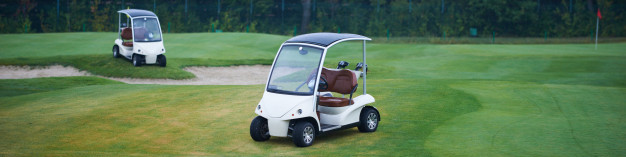 Two electric golf carts on a golf course