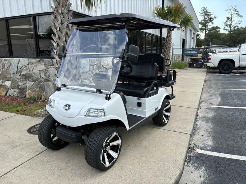 White golf cart parked outside a building